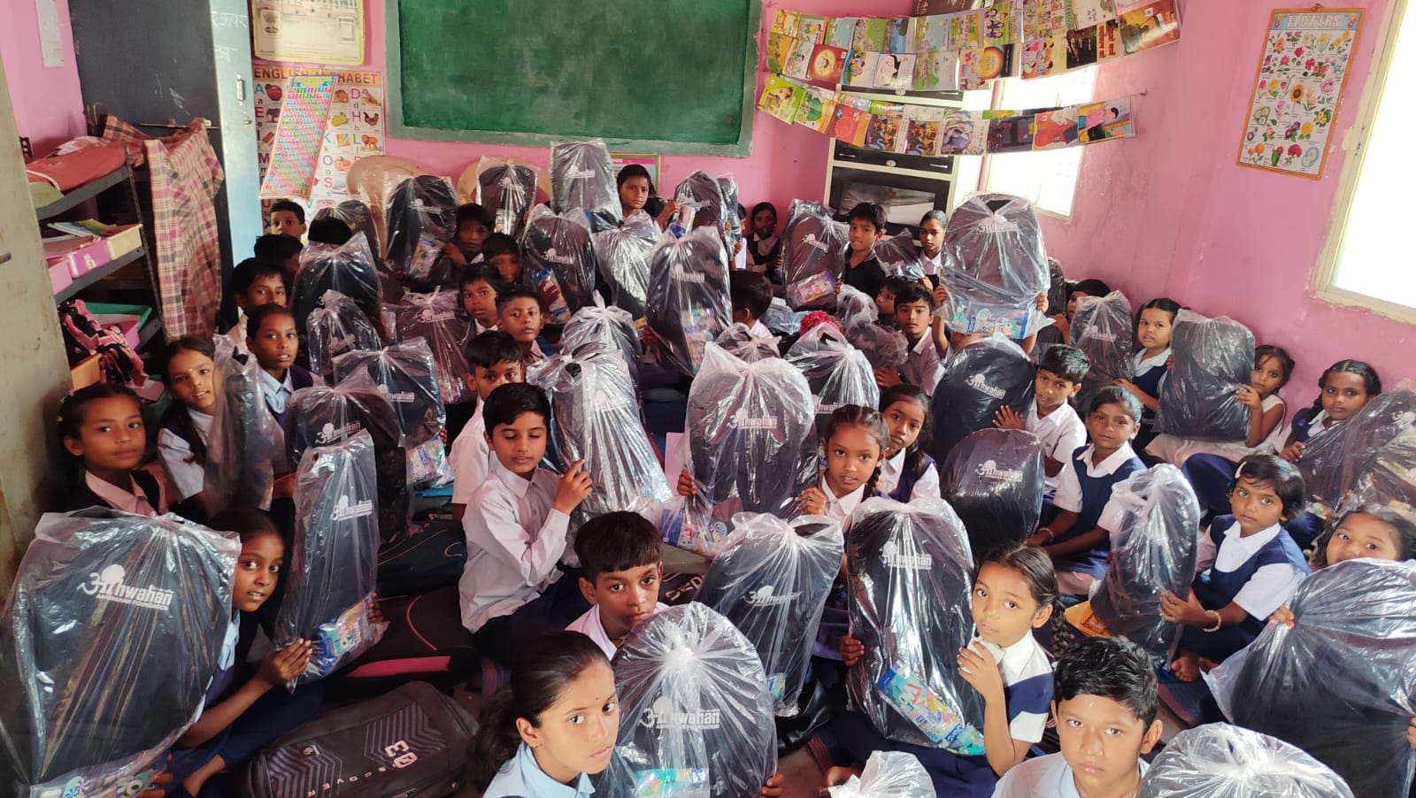 Children receiving happiness kits from an Aahwahan programme