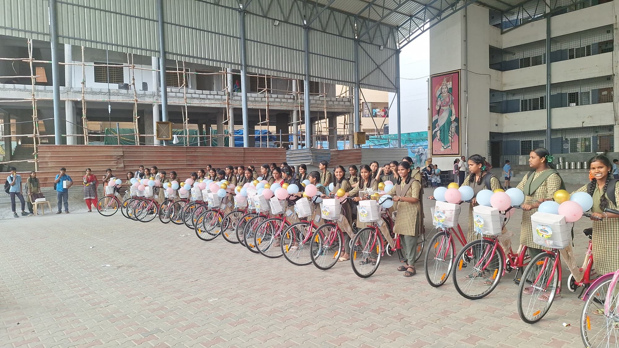 Schoolgirls standing with the bicycles they have just been given through Project Udaan
